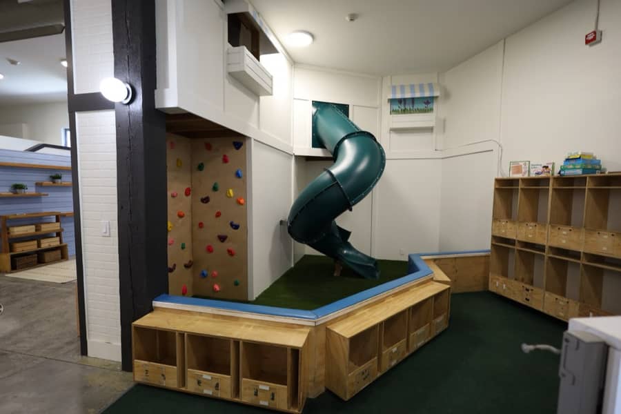 An indoor climbing wall and spiral slide