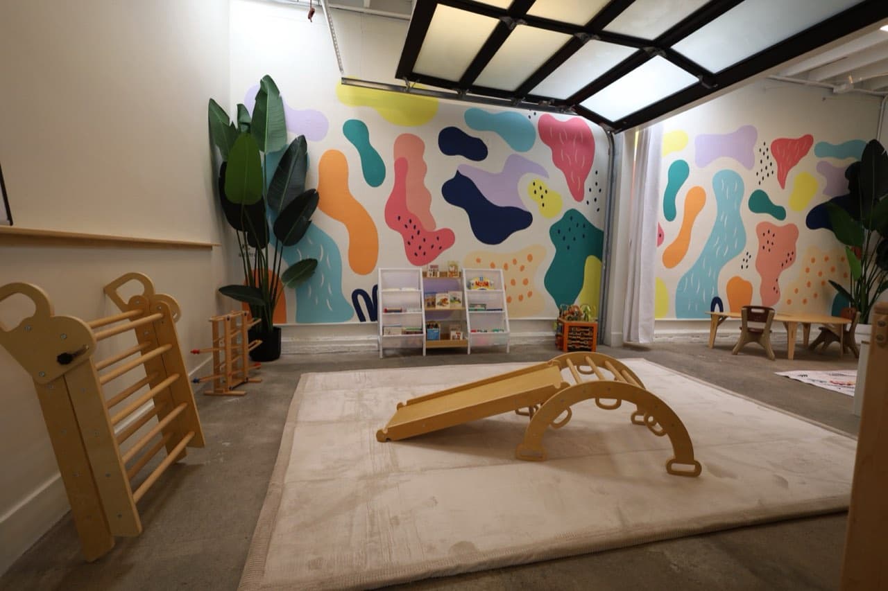 Wooden climbing toys in the colorful Footsteps playroom